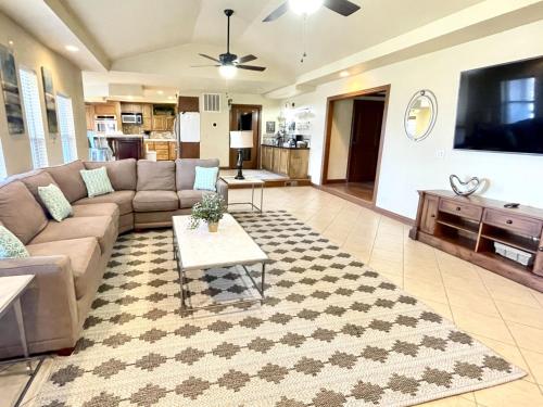a living room with a couch and a tv at Beaver Lake Getaway in Rogers