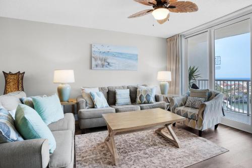 a living room with a couch and a table at Pelican Beach Terrace 805 in Destin