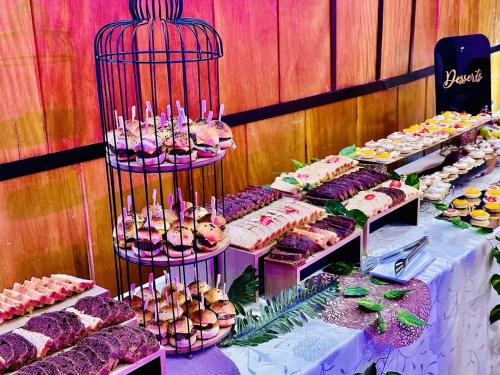 a table with many different types of cakes and pastries at Yaahot in Yaoundé