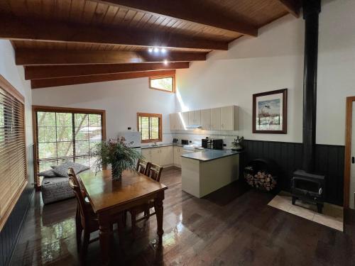 a kitchen and dining room with a table and a dining room at The Kingfisher Lodge 111 in Halls Gap