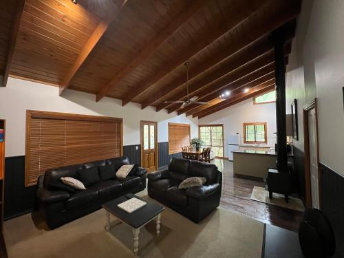 a living room with a couch and a table at The Kingfisher Lodge 111 in Halls Gap