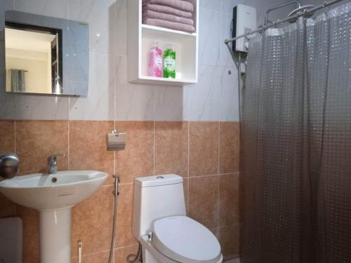a bathroom with a toilet and a sink and a shower at Angeles Private Pool Villa in Angeles