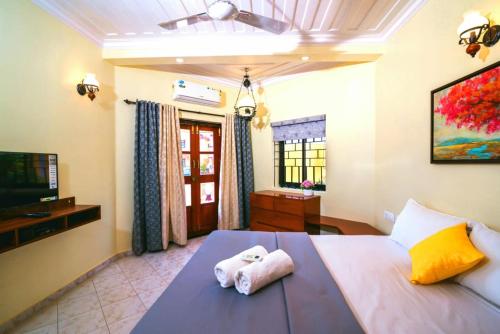 a bedroom with a bed with towels on it at 'Golden Sea Pearl' 1 bhk Beach apartment in Benaulim