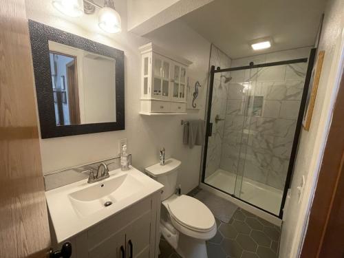 a bathroom with a toilet and a sink and a shower at Our Cozy Getaway in Ocean Park