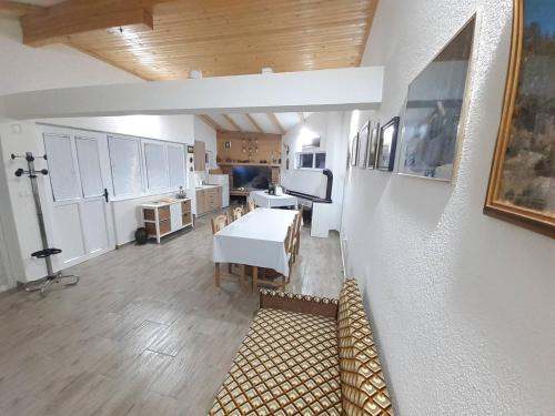 a kitchen with a white table and a dining room at Apartman Prenj in Konjic