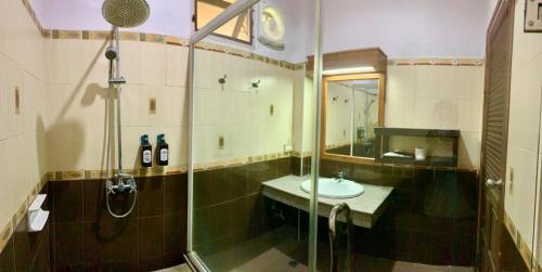 a bathroom with a shower and a sink and a shower at Baan Soontree Resort in Chiang Rai