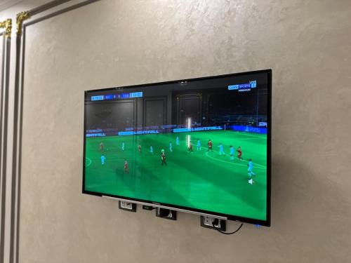 a flat screen tv hanging on a wall at Villa 267 Residence in Cairo