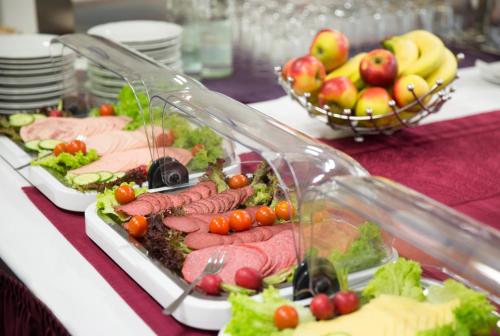 a buffet of food on a table with fruits and vegetables at Hotel Alte Fabrik in Mettmann