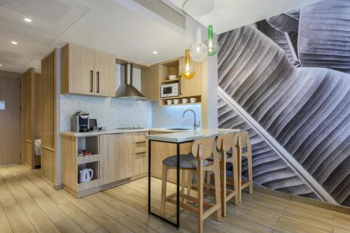 a kitchen with a table and chairs and a staircase at Royal Garden by Isrotel Collection in Eilat