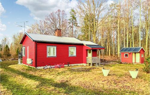 a red house in the middle of a yard at 1 Bedroom Cozy Home In Odensbacken in Stora Mellösa