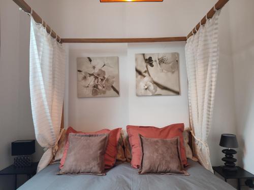 a bedroom with a bed with three pictures on the wall at The Manhattan Luxury suite in Jumet
