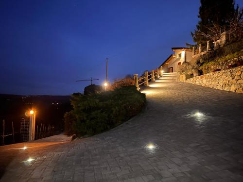 a stone pathway at night with lights on it at b&b Antiche Pietre in Bollengo
