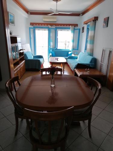 a living room with a table and a couch at Villa Evmenia Panoramic sea view & Sea front apartments in Skopelos Town