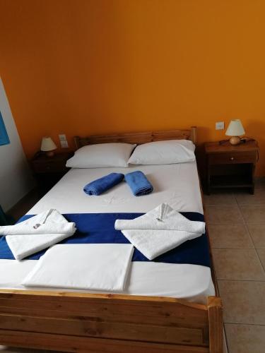 a bedroom with a bed with towels on it at Villa Evmenia Panoramic sea view & Sea front apartments in Skopelos Town
