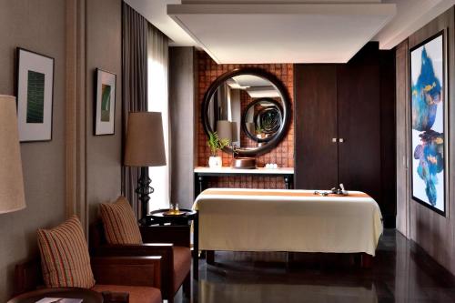 a room with a large bed and a mirror at Weligama Bay Marriott Resort & Spa in Weligama