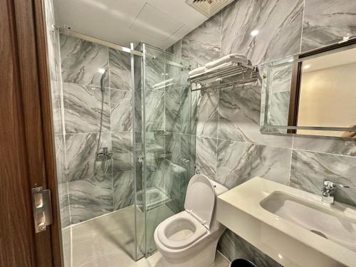 a bathroom with a shower and a toilet and a sink at Riverside 1 Hotel in Can Tho