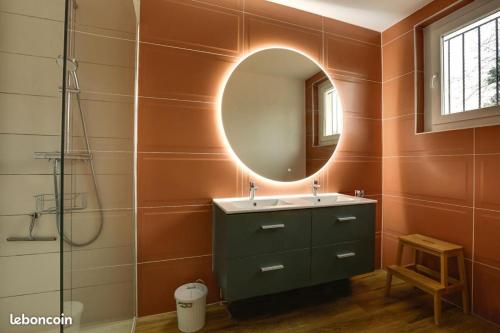 a bathroom with a sink and a mirror at VILLA LUNA - 9 couchages - terrain pétanque - wifi - netflix in Capbreton