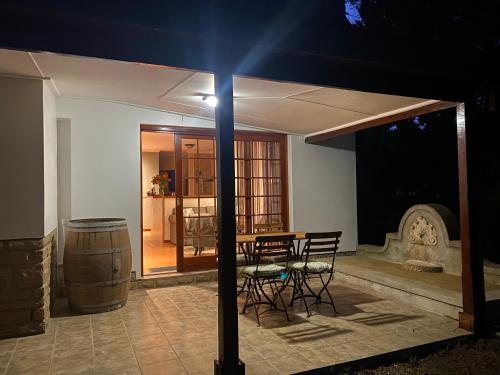 a room with a table and chairs and a barrel at Eden Studios in Riebeek-Kasteel