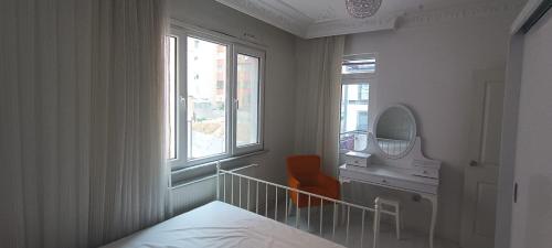 a bedroom with a bed and a sink and a mirror at Mutlu Apart in Istanbul