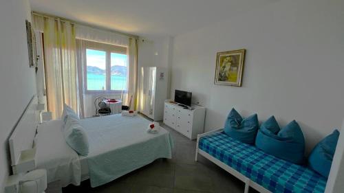 a bedroom with a bed and a couch and a window at B&B Camera Bellavista in Lerici