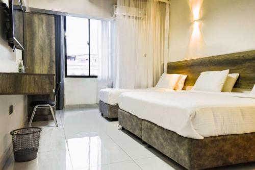 Ένα ή περισσότερα κρεβάτια σε δωμάτιο στο The Ivory Suites