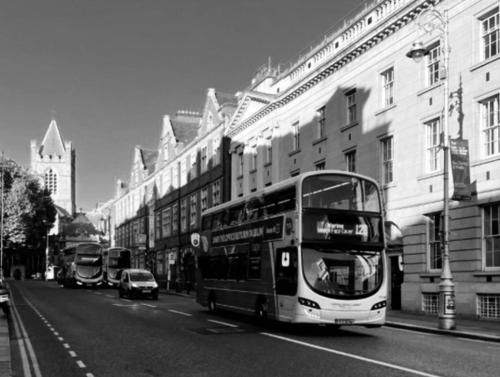 a double decker bus driving down a city street at Shared Flat in Dublin