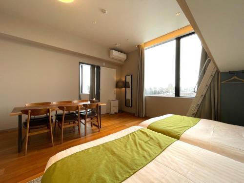 Riverside Hotel Sapporoにあるベッド