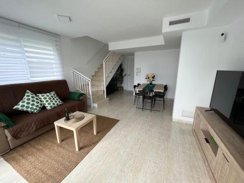 a living room with a couch and a table at Casa Sete in Alcanar