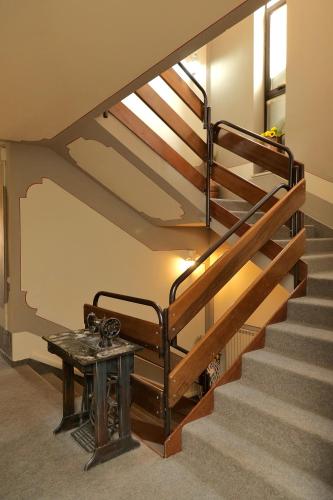 a staircase with a wooden rail and a table at Hotel Andreis in Cavaion Veronese