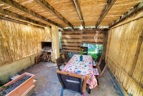 a room with a table and chairs in a shed at Villa Laura - Putzu Idu in Putzu Idu