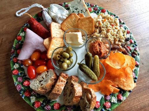 a plate full of different types of food on a table at Cabane Les Pourettes in Feusines