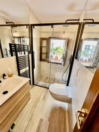 a bathroom with a shower and a toilet and a sink at Gorgeous sunlit townhouse with terrace in medieval Pescia, Tuscany in Pescia