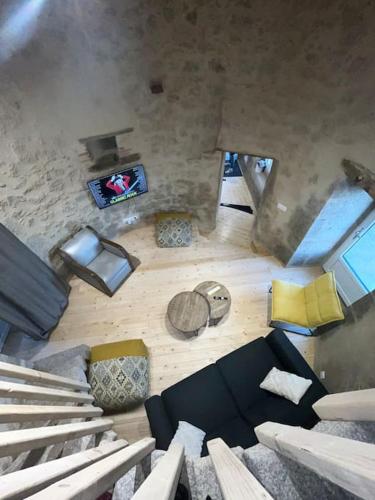 an overhead view of a living room with a couch at loue ancien moulin a vent avec piscine et jacuzzi in Neuvy-Bouin