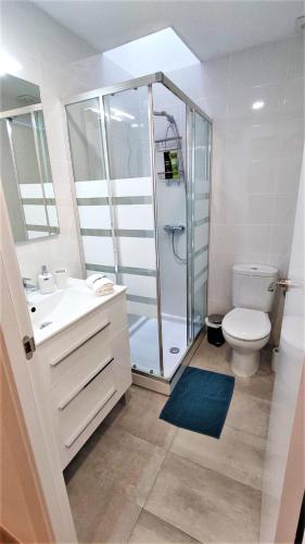a bathroom with a shower and a toilet and a sink at EMILY BEACH-CITY Apartment in Montgat