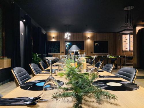 a long table in a room with chairs and a table with wine glasses at Jelenia Struga MEDICAL SPA in Kowary