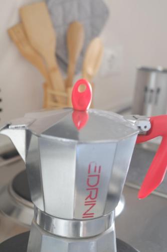 a blender with a red spoon on top of it at Casa Barcelli Sport & Family Apartments in Nago-Torbole
