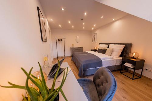 a bedroom with a bed and a table and chairs at BONNYSTAY Landshut Monument in Landshut