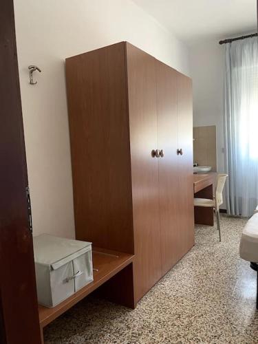 a large wooden cabinet in a room with a desk at Bungalows Alloggi Angiolin Ketty in Cavallino-Treporti