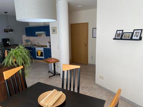 a kitchen and dining room with a table and chairs at FeWo Roland Ranft direkt am Kurpark Barrierearm 60qm in Bad Elster