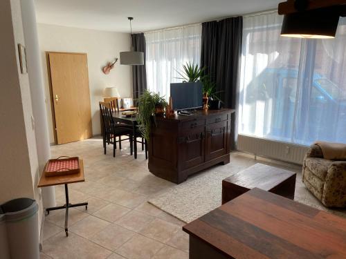 a living room with a kitchen and a dining room at FeWo Roland Ranft direkt am Kurpark Barrierearm 60qm in Bad Elster