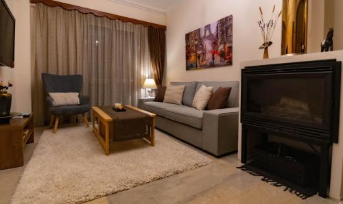 a living room with a couch and a fireplace at Angel Mezonet in Amaliás