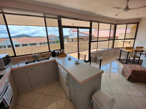 a kitchen with a view of a living room at Tuggeranong Short Stay #08 - Sleeps 6 in Tuggeranong