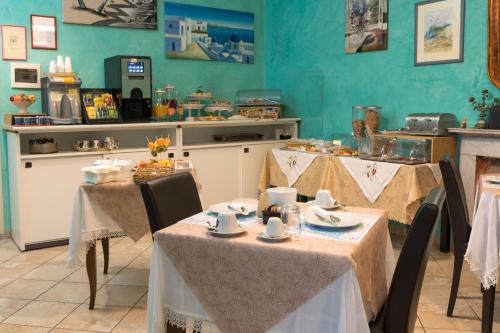 ein Restaurant mit zwei Tischen und einer Theke mit Speisen in der Unterkunft Locanda dei Fiori in Pistoia