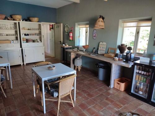 a kitchen with a counter and a table in a room at Quinta Pereiro Tropic Garden, Algarve in Moncarapacho
