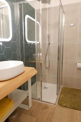 a bathroom with a sink and a shower at Casa Barcelli Sport & Family Apartments in Nago-Torbole