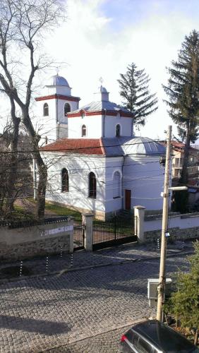 a large white building with a fence in front of it at Family Hotel Bansko Sofia in Sofia
