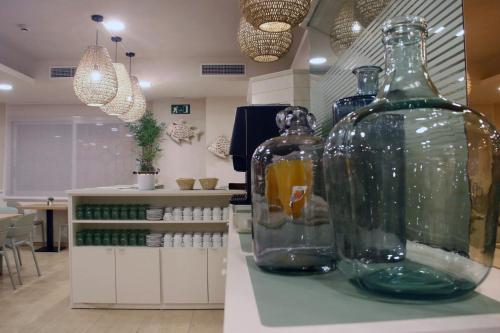 a room with two large glass bottles on a counter at Hotel Miramar in Lloret de Mar
