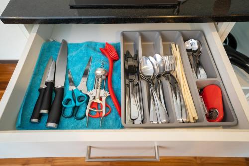 a drawer filled with lots of kitchen utensils at The Title Rawai West Wing Pool View Suite in Rawai Beach