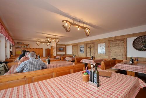 a restaurant with tables and people sitting at tables at Rifugio Fronza alle Coronelle - Kölner Hütte in Nova Levante