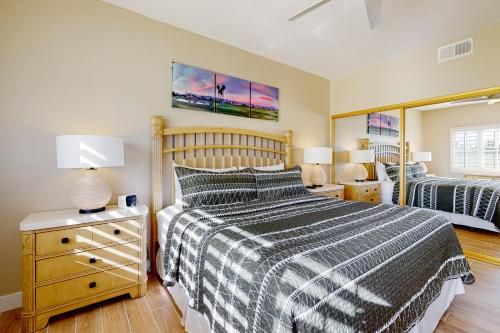 a bedroom with a bed and a mirror at The Gem of Palm Desert in Palm Desert